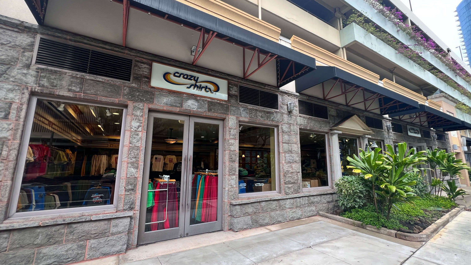 Ward Village Storefront with 'Crazy Shirts' sign and clothing displayed inside