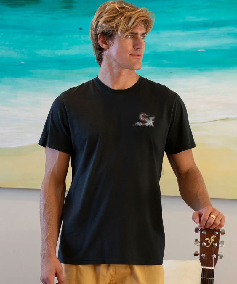 Man wearing a black t-shirt with a logo on a beach View 3