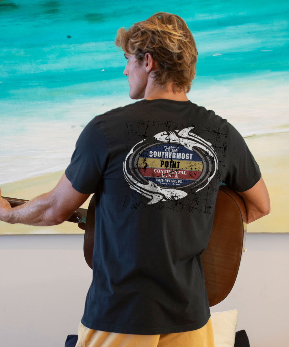Man holding a guitar with a branded t-shirt on a beach View 2