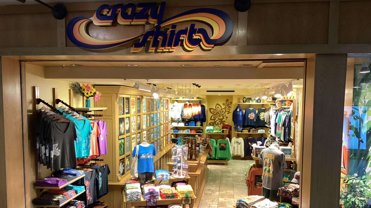 Pearlridge Store interior with 'Crazy Shirts' sign and clothing displays.