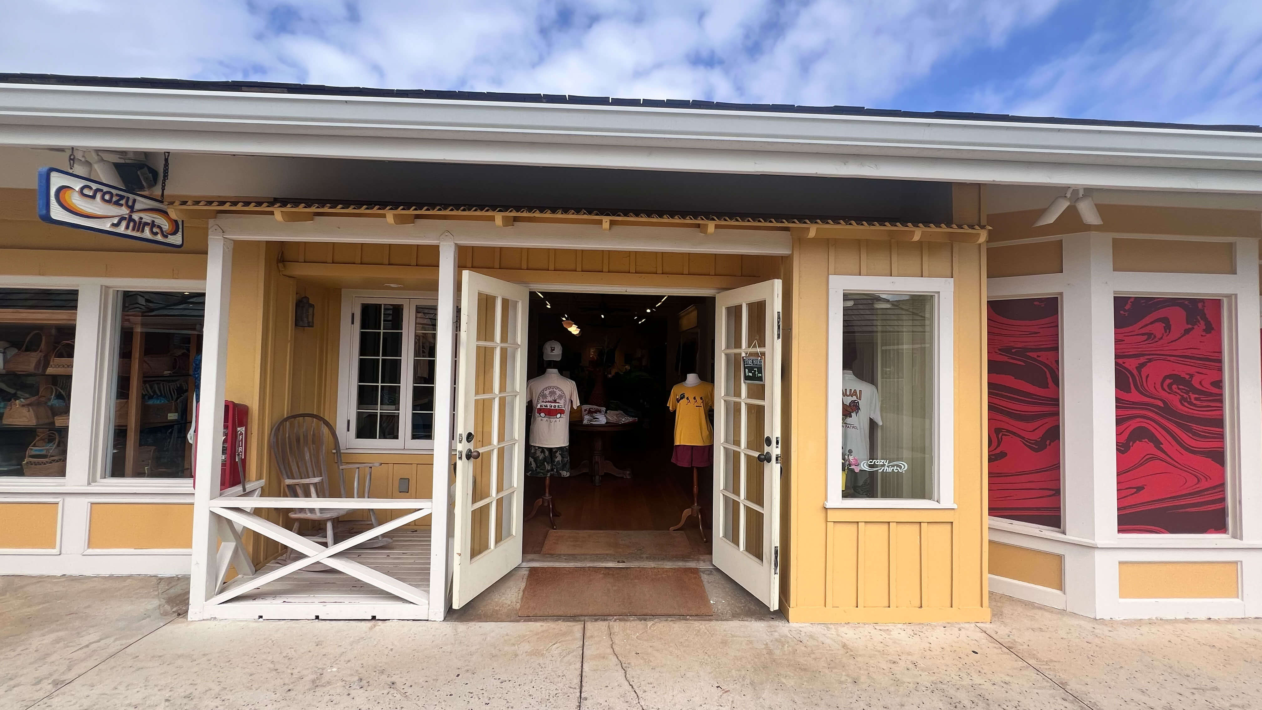 Coconut Marketplace Kauia storefront with open doors, people inside, and a clear sky.