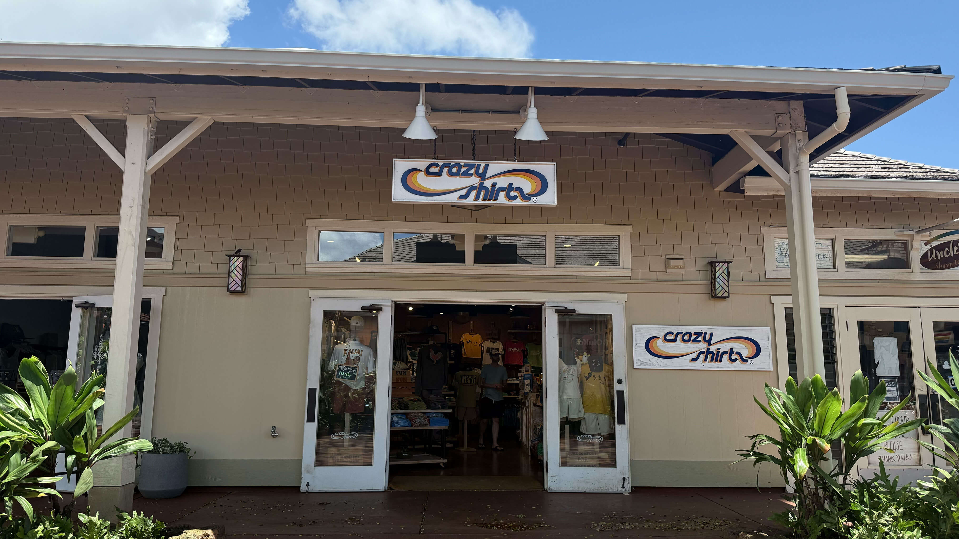 Kukui'ula Storefront with 'crazy shirts' sign on a sunny day