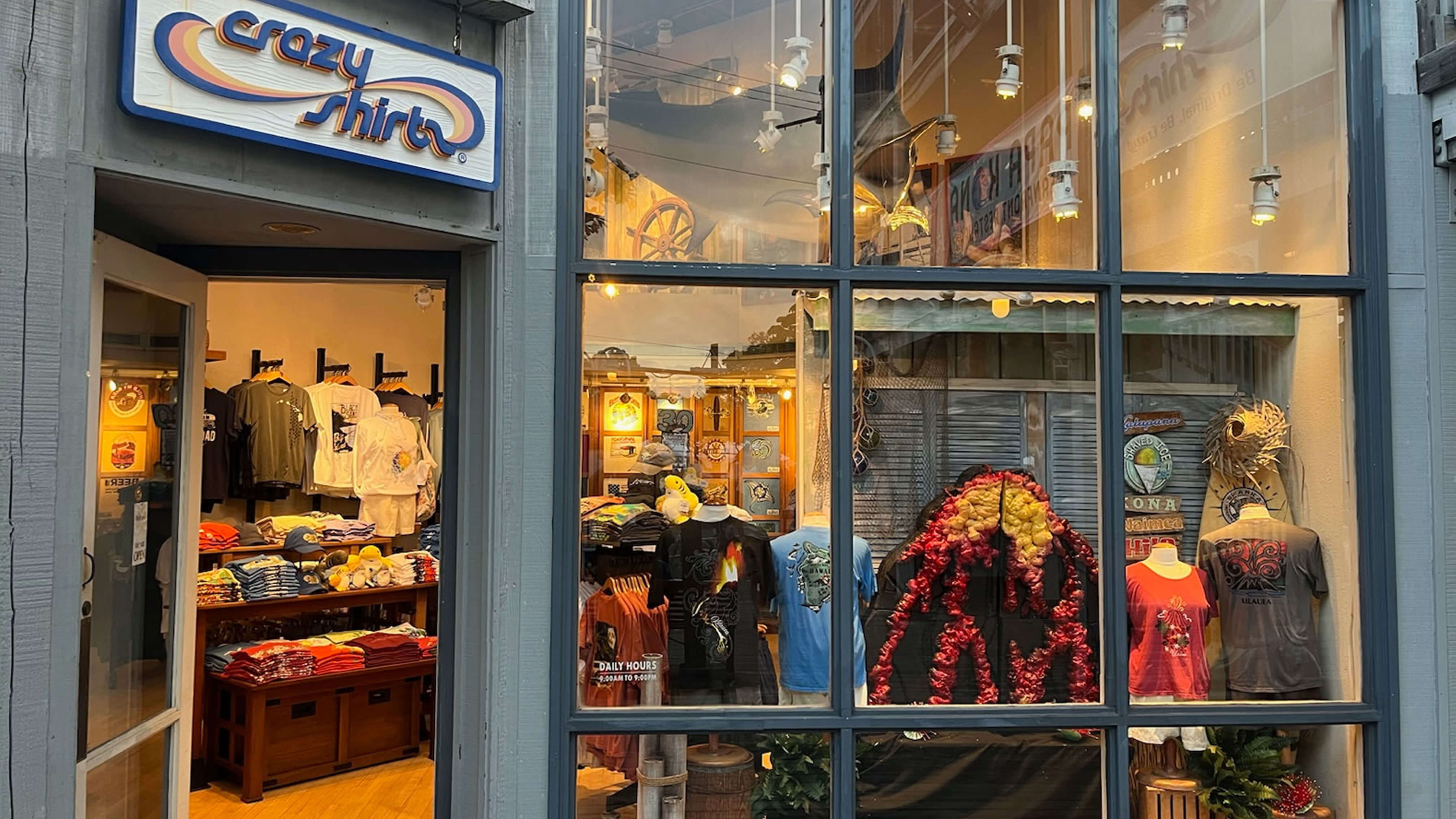 Kona Waterfront storefront with 'crazy shirts' sign and display of clothing and accessories.