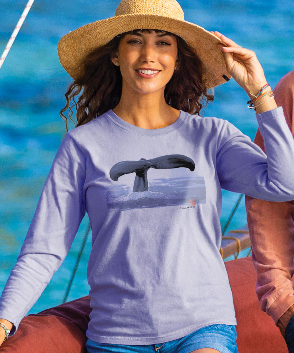 A woman wearing a wide-brimmed hat and a lavender long sleeve crewneck t-shirt with a whale tail graphic on the front. View 2