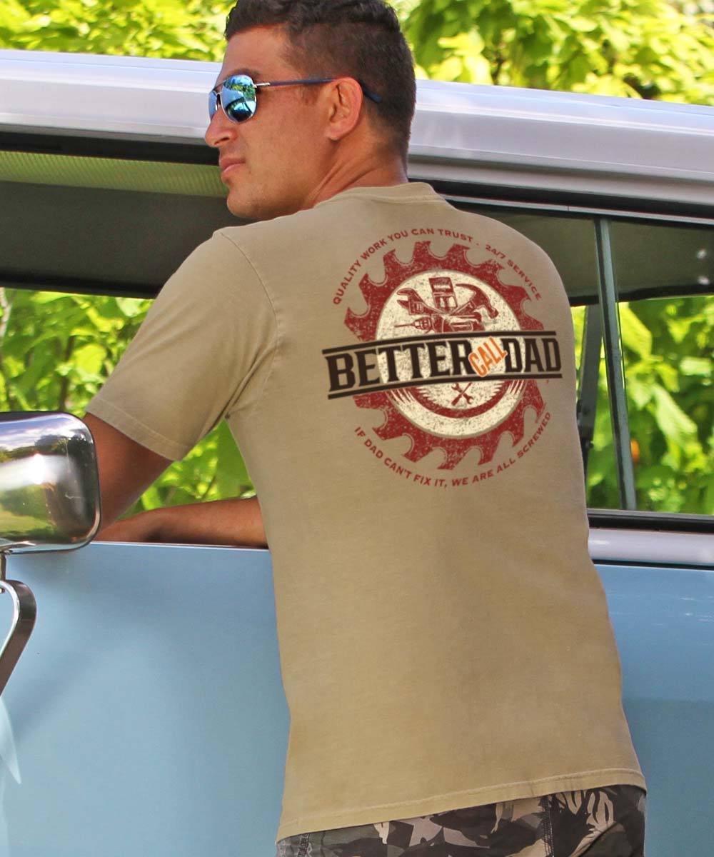 A person wearing a beige short-sleeve crewneck t-shirt with the text 'BETTER CALL DAD' and a graphic related to coffee. View 2