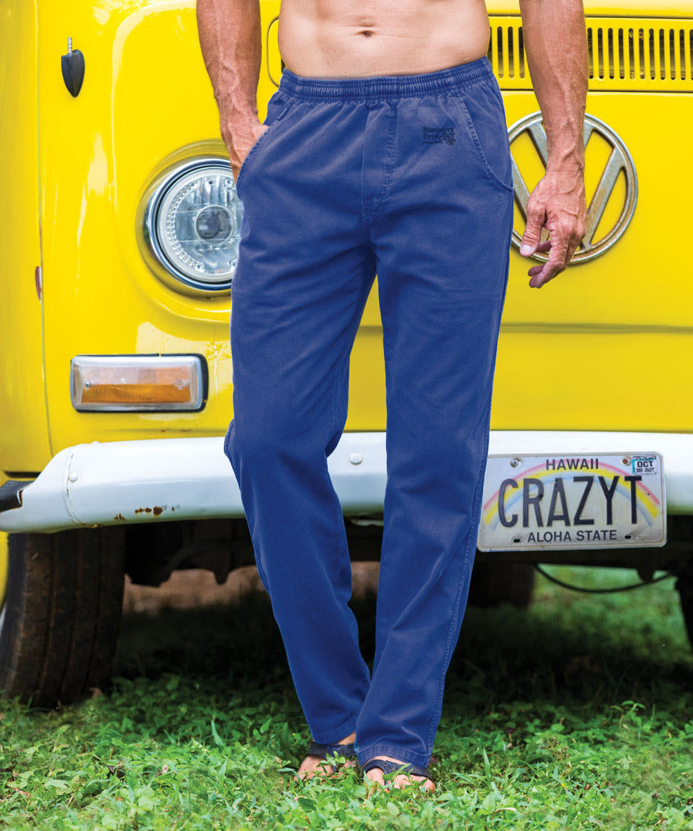 A person standing in front of a yellow vehicle wearing blue twill pants with an elastic drawstring waistband. View 2