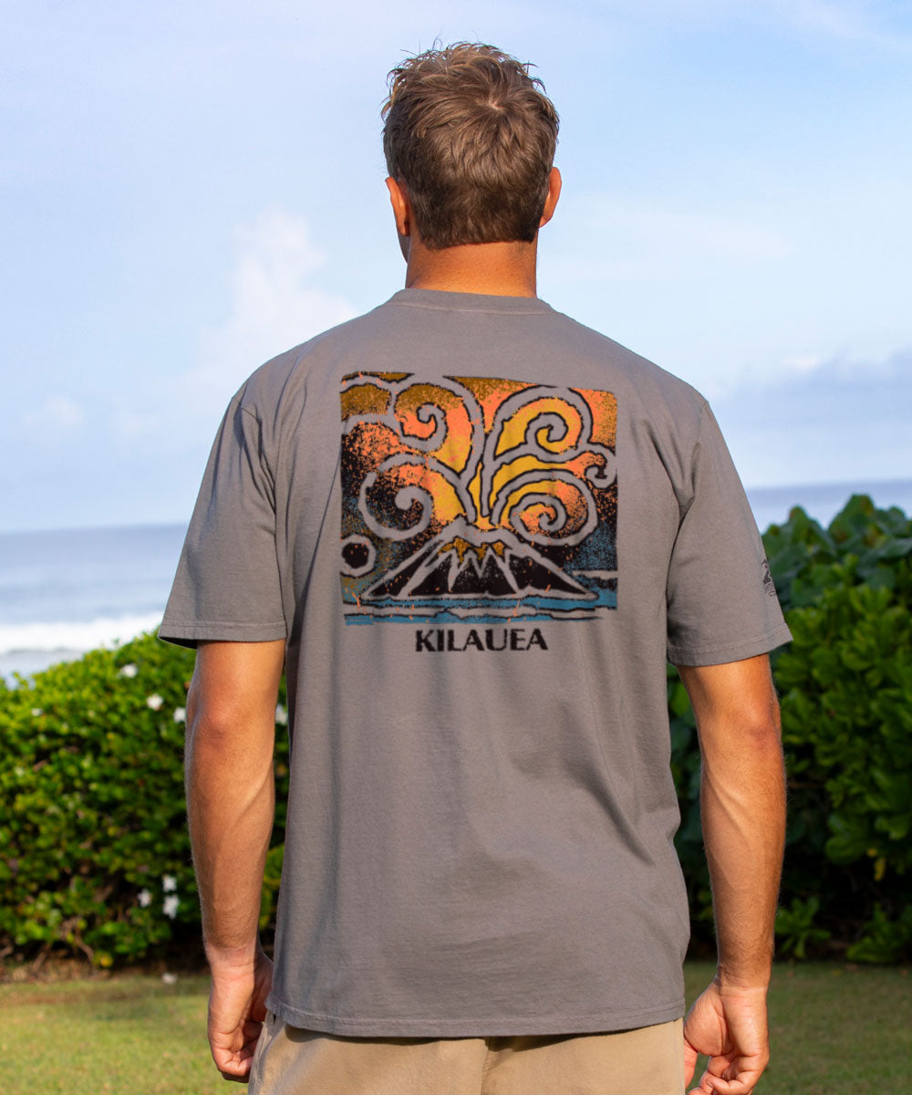 Man wearing a gray t-shirt with a colorful design and 'Kilauea' text outdoors. View 2