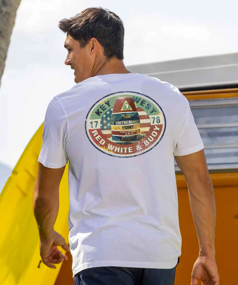 Man wearing a white t-shirt with a colorful graphic on the back, holding a yellow surfboard. View 2