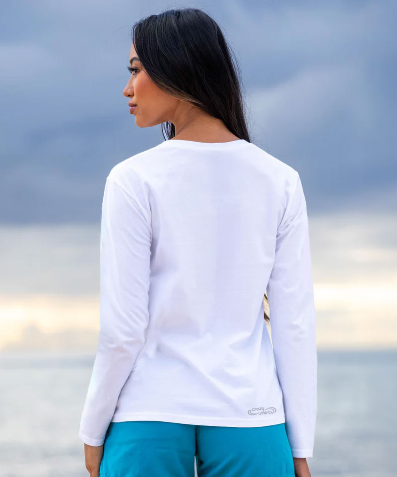 Woman wearing a white long-sleeve shirt, standing against a cloudy sky. View 3