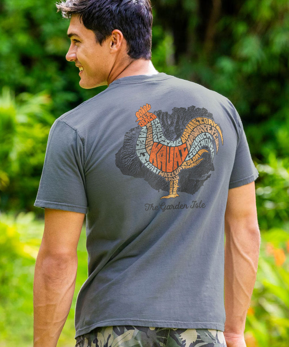 Man wearing a gray t-shirt with a colorful rooster design and text on the back, standing outdoors. View 2