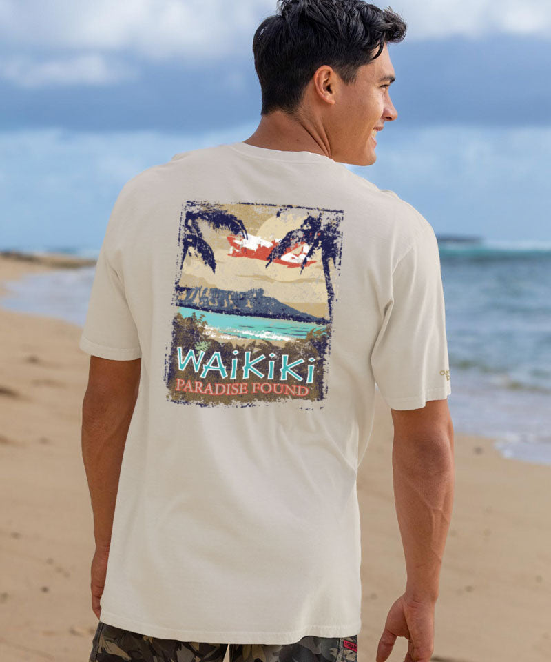 Man wearing a 'Waikiki Paradise Found' t-shirt on a beach View 2