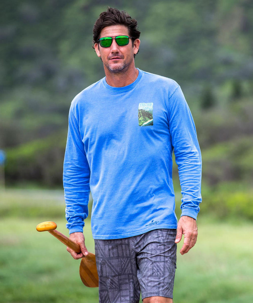 Man in blue shirt and sunglasses holding a paddle in a natural setting View 3