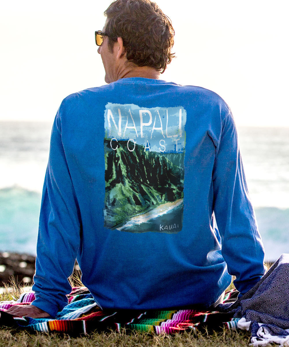 A person facing away from the camera wears a blue long sleeve crewneck t-shirt with a printed image of the Napali Coast on the back. View 2
