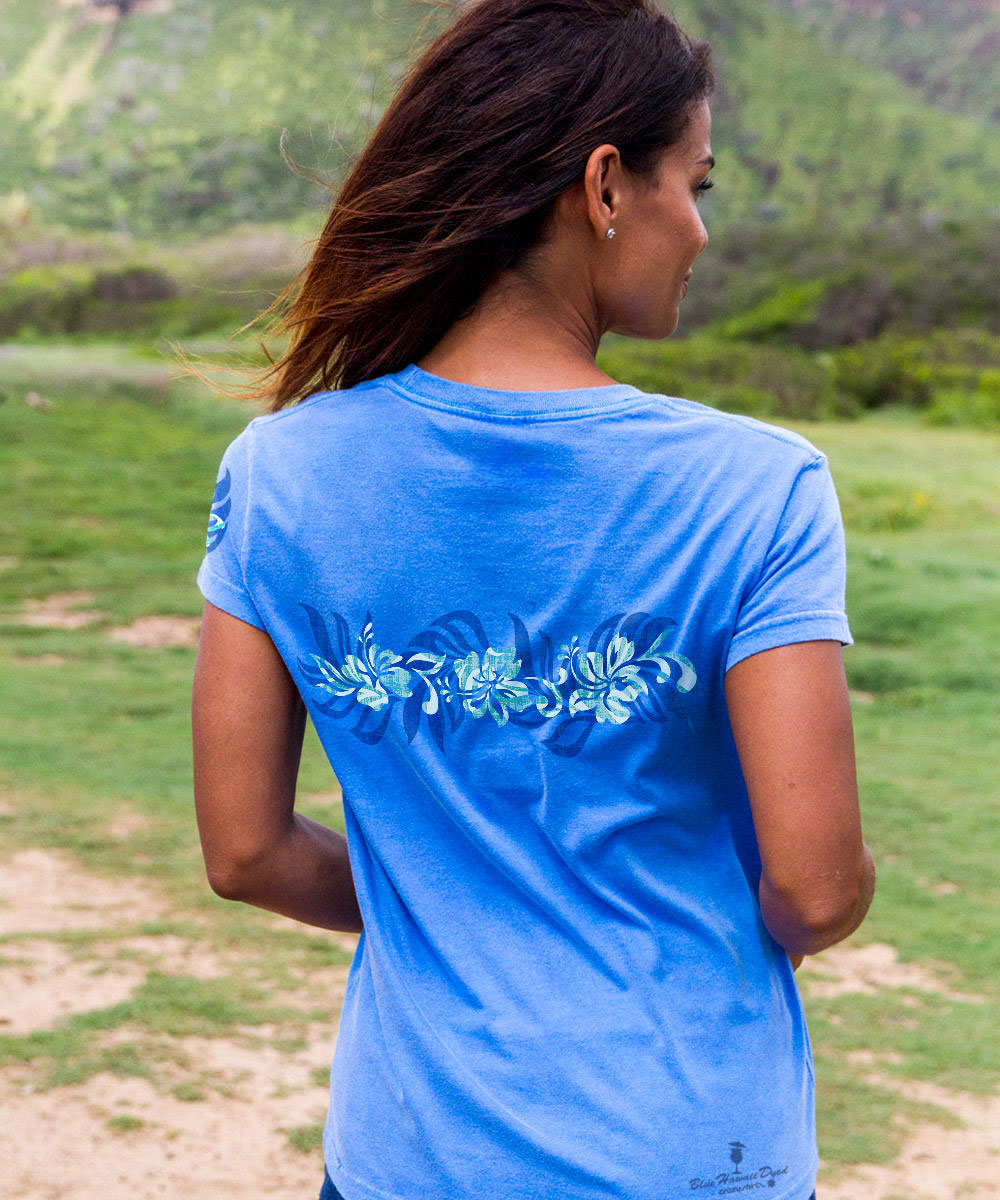 Woman wearing a blue t-shirt with a floral design in a natural setting View 3
