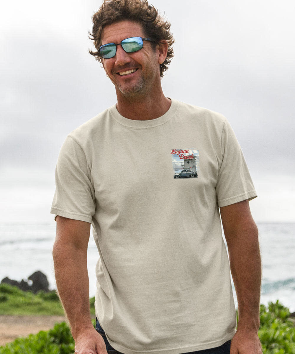 Man wearing sunglasses and a beige t-shirt with a graphic design outdoors View 3