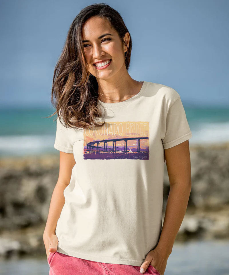 Woman wearing a t-shirt with a graphic design on a beach View 2