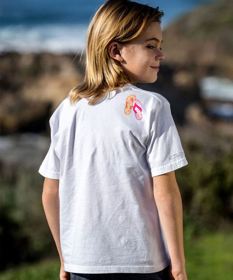 Person wearing a white t-shirt with a colorful design on the back, standing outdoors. View 3