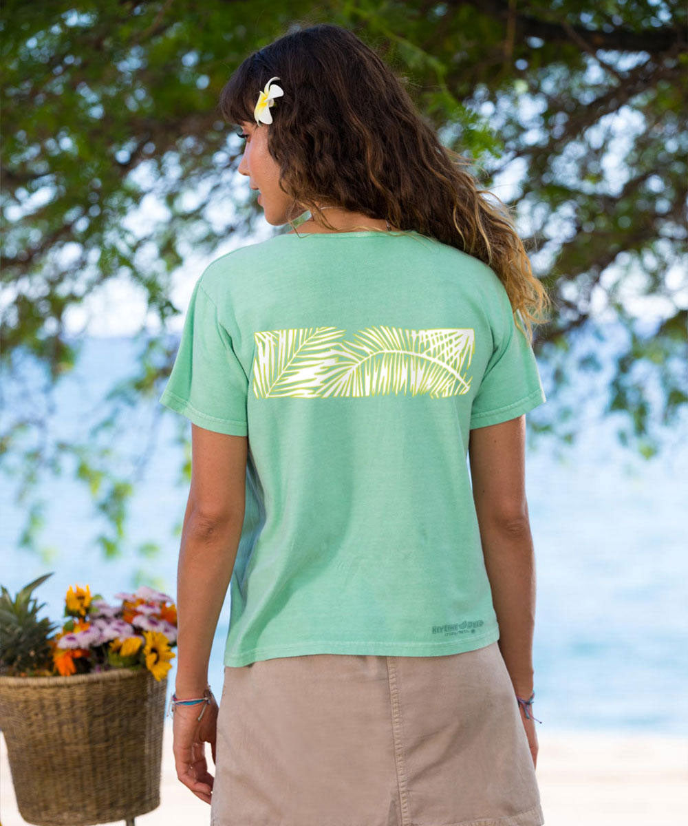 Woman standing looking at the ocean wearing a green scoop neck t shirt View 3