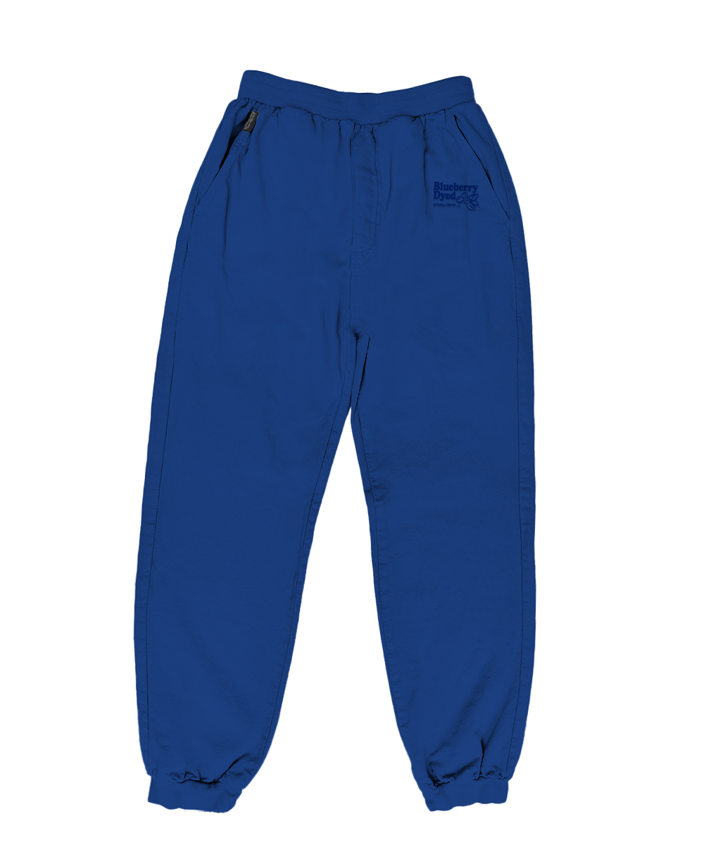Blue canton pants with a logo on the pocket against a white background View 1