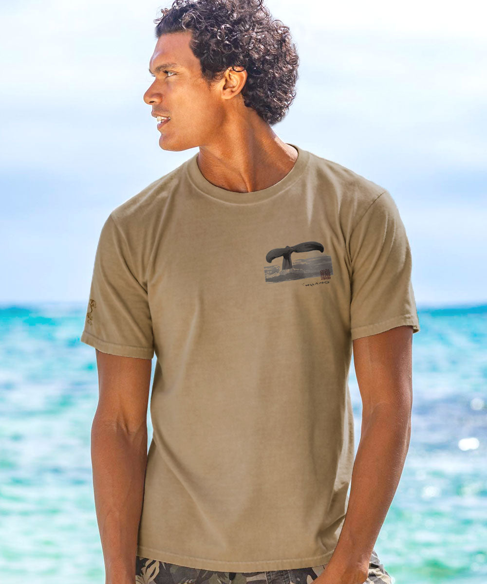 Man wearing a beige t-shirt with a graphic on a beach. View 3