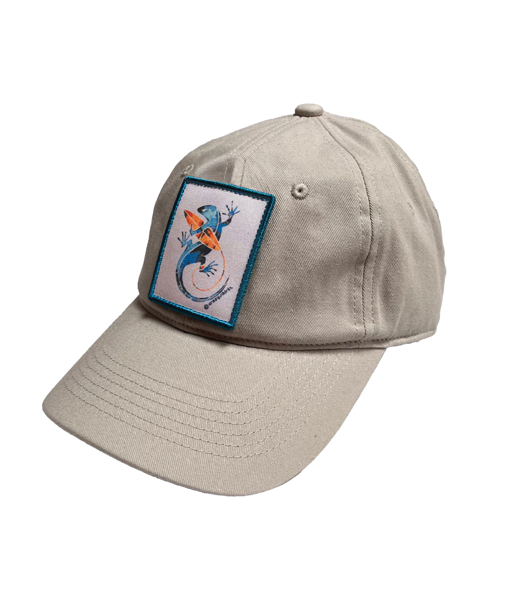 Beige cap with a colorful patch featuring a lizard with a surf board design on a white background View 1