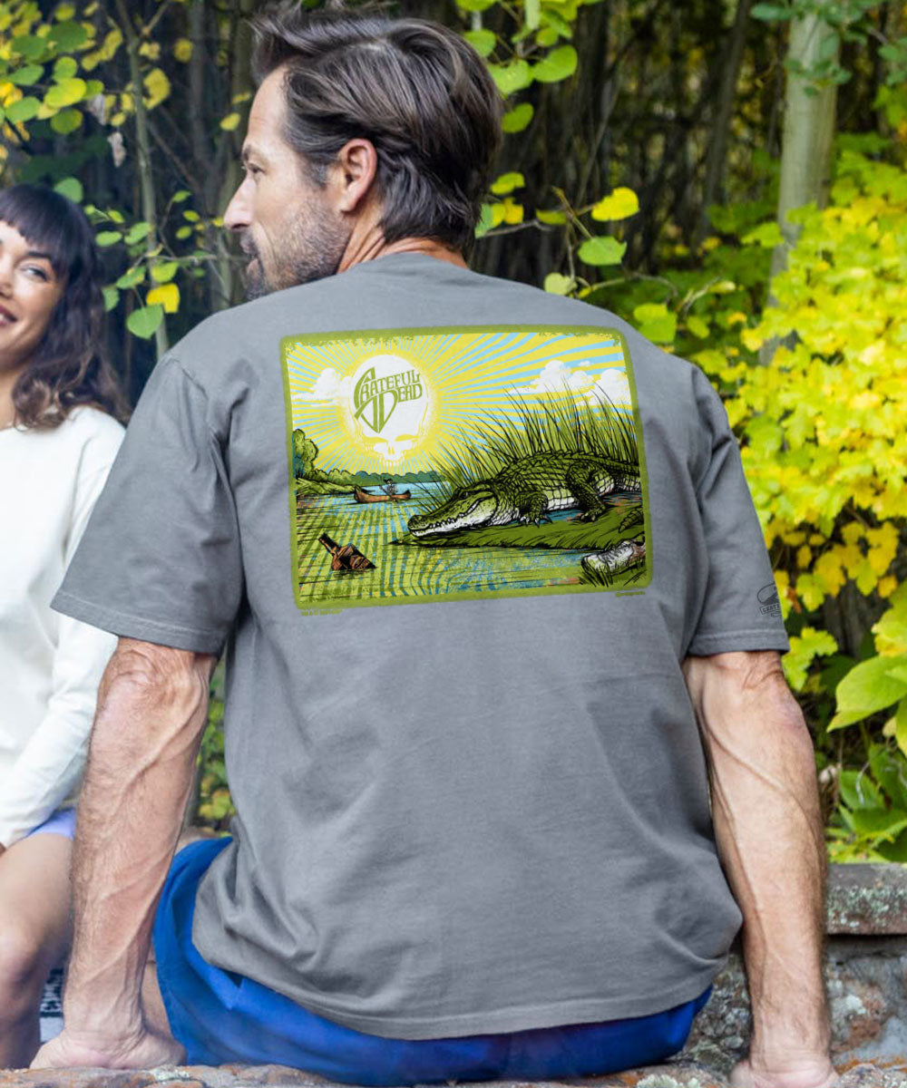 A person wearing a short sleeve crewneck t-shirt with a graphic of an alligator on the back. View 2