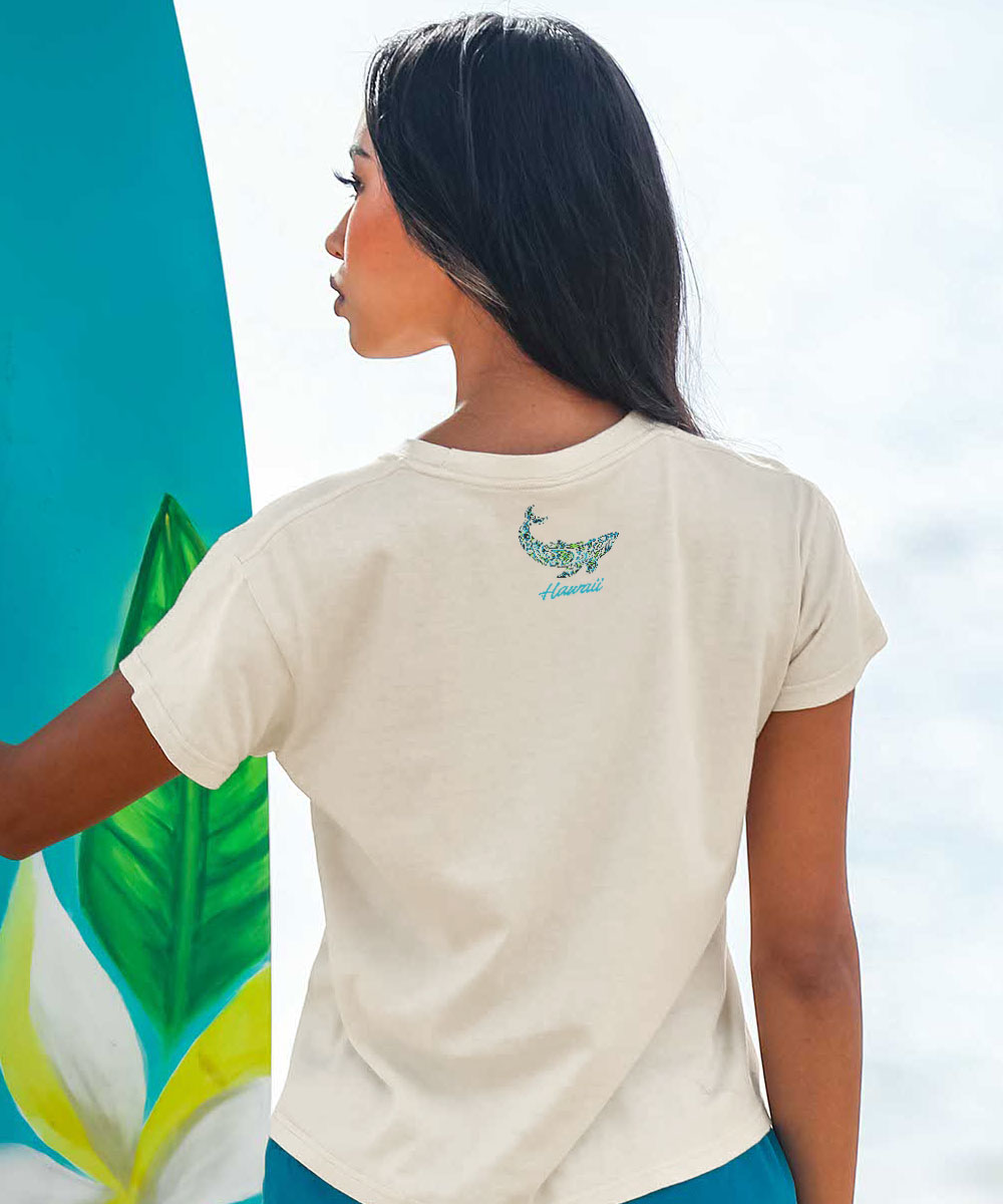woman wearing a beige t shirt holding a surf board View 3