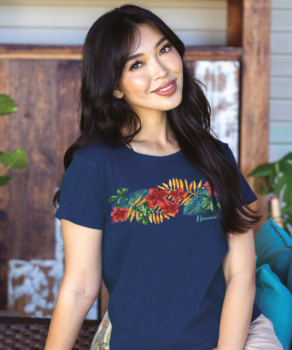 Woman wearing a navy blue t-shirt with colorful floral design outdoors. View 2