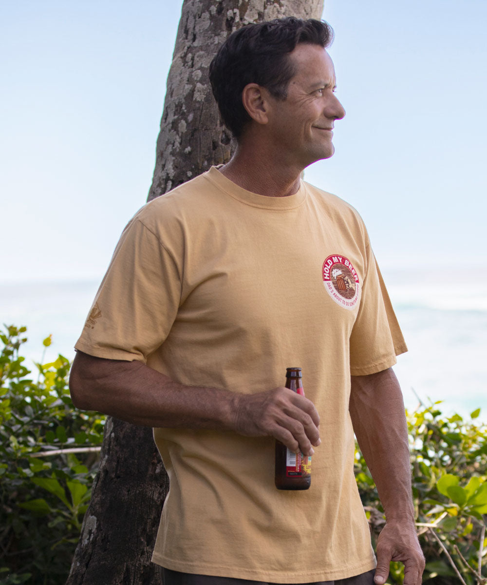 Man wearing beige t shirt and holding a beer View 3