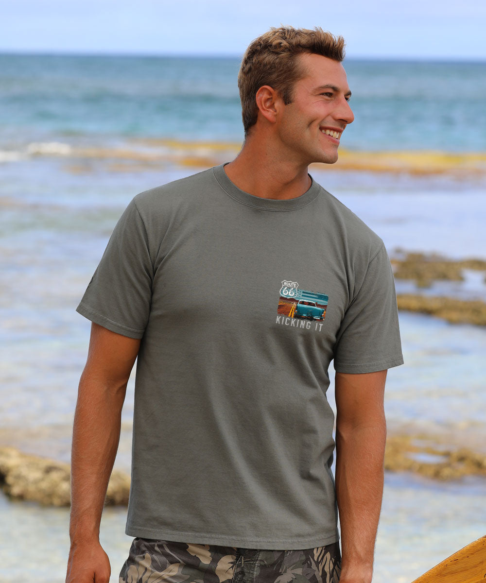 Man wearing a gray t shirt by the beach View 3