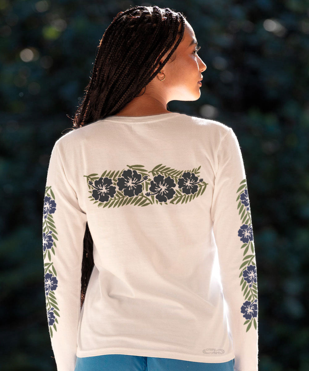 A woman wearing a white long sleeve crewneck t-shirt with a floral band design in blue colors on the sleeves. View 3