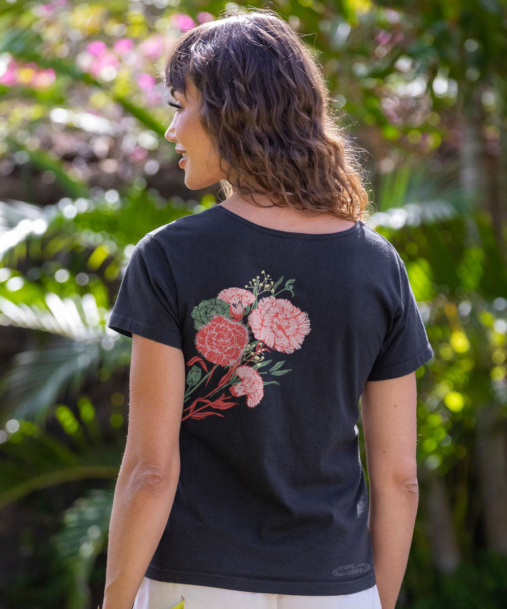 Woman wearing a black t-shirt with pink floral design outdoors View 3