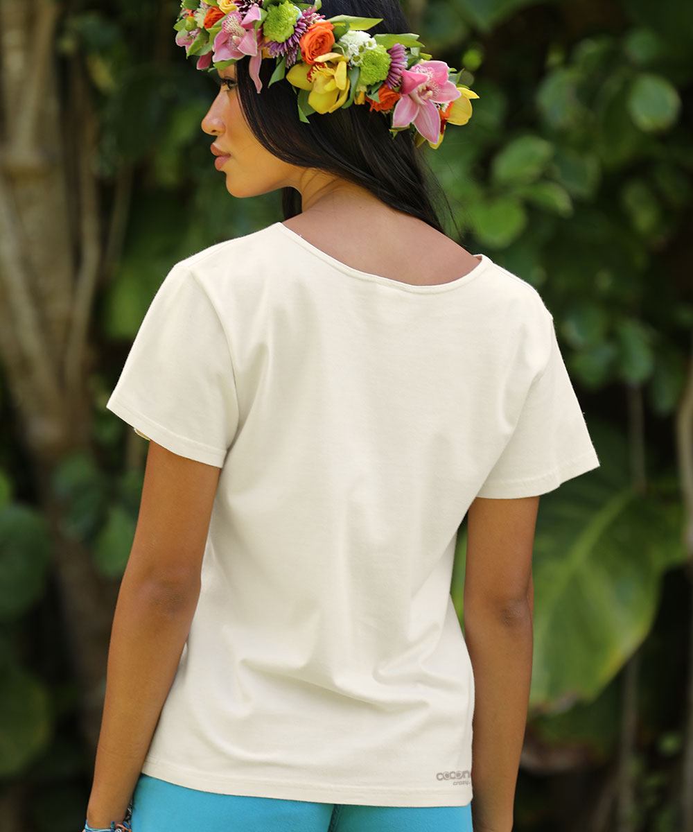 Person wearing a white t-shirt with a floral headband in a natural setting View 3