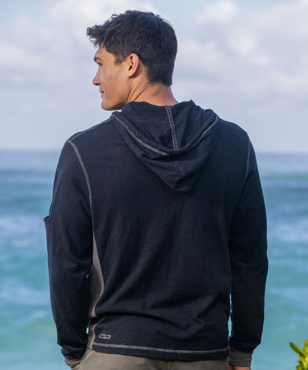Man wearing a dark gray hoodie standing by the ocean View 3