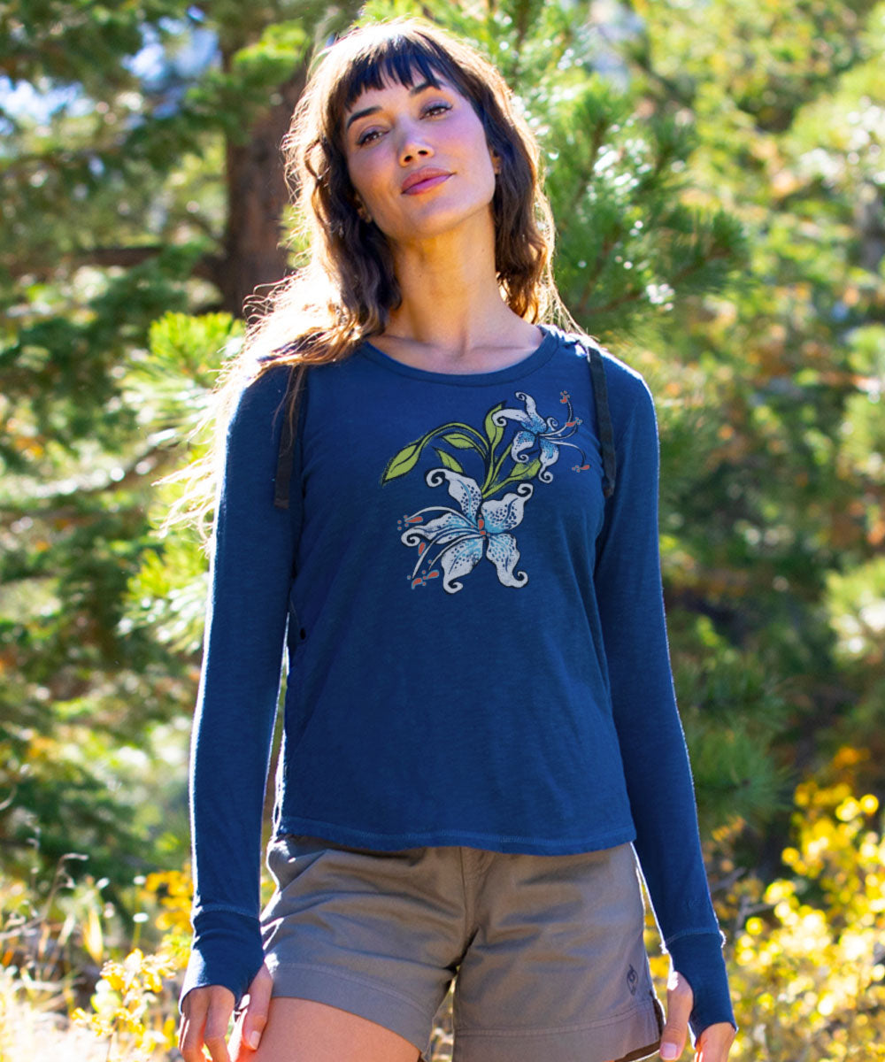 Woman wearing a blue long-sleeve shirt with a butterfly design outdoors. View 2