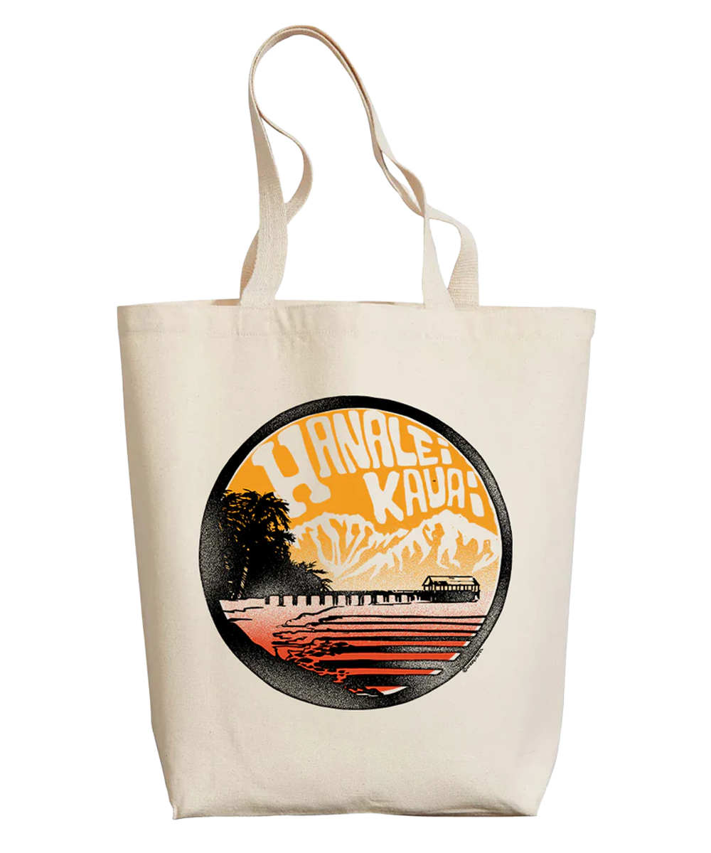 Beige tote bag with a circular design featuring mountains and trees on a white background View 1