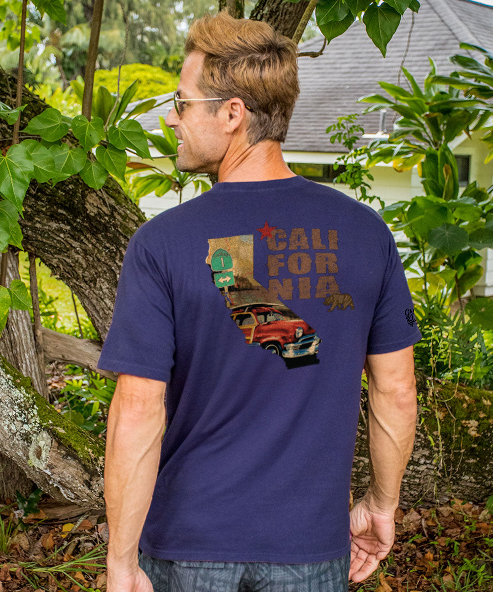 Man wearing a purple t-shirt with a graphic design on the back standing outdoors View 2