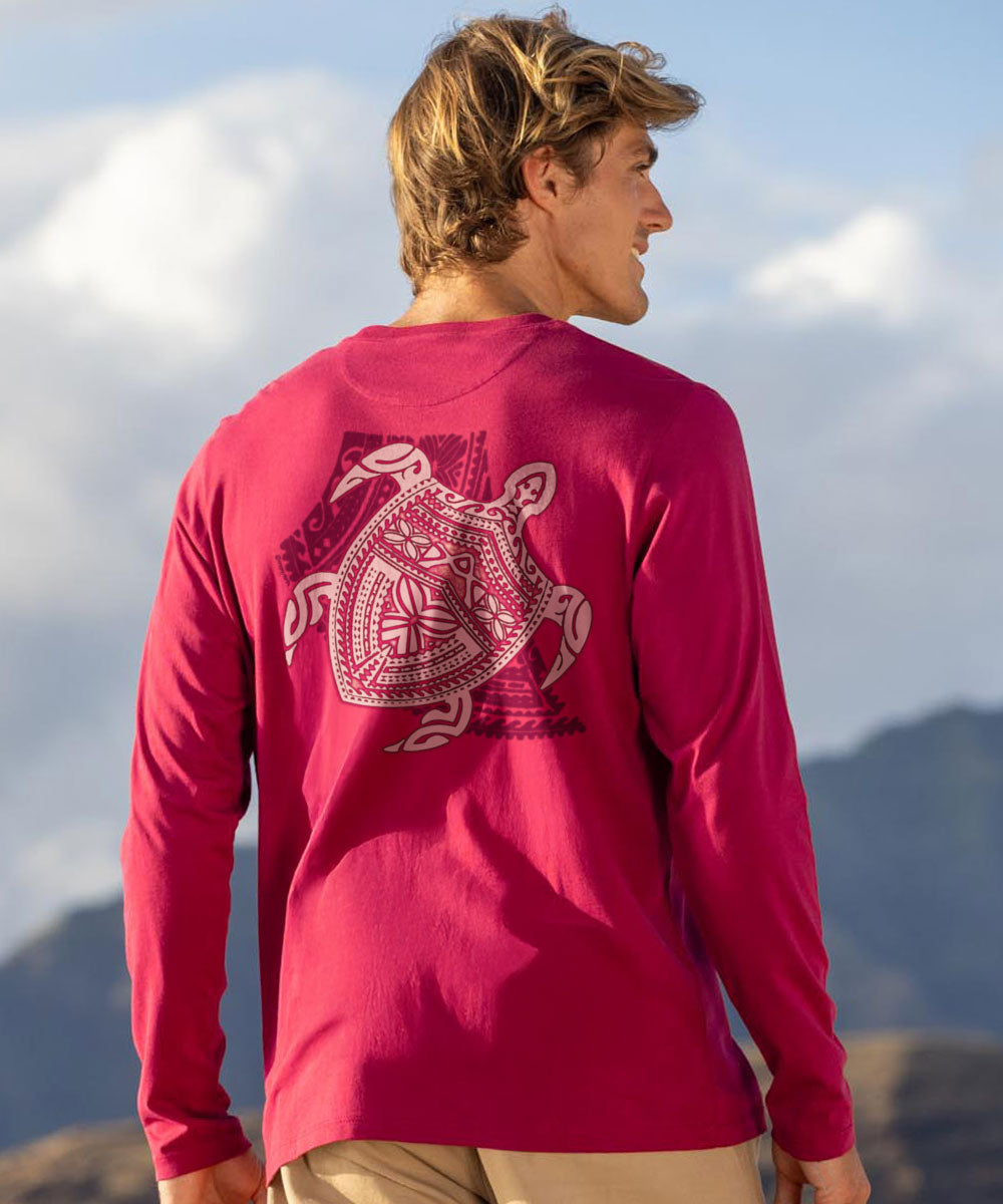 Man wearing a dark red long-sleeve shirt with a turtle graphic design on the back, standing against a mountainous landscape. View 2