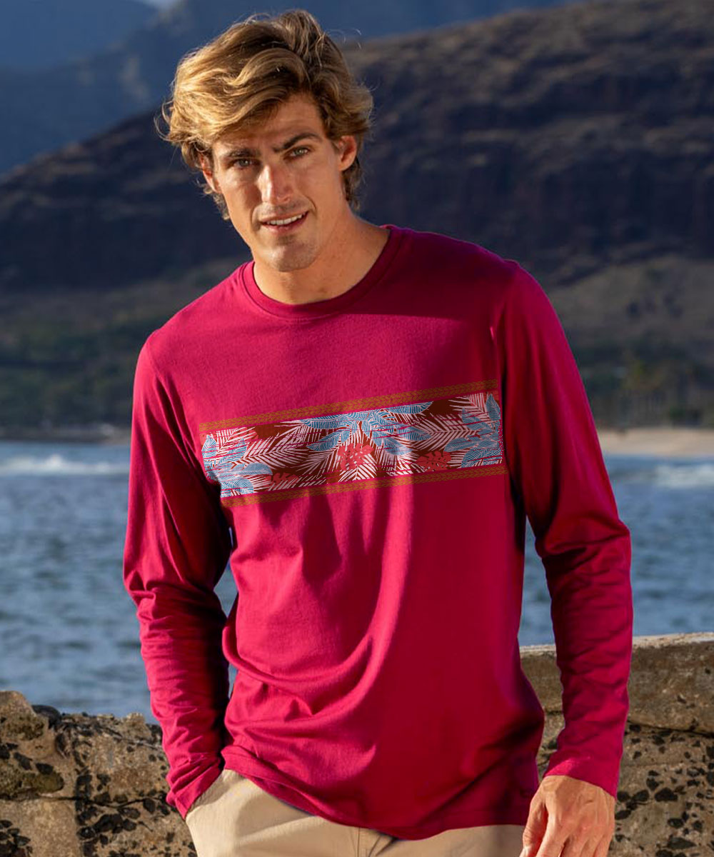 Man wearing a red long-sleeve shirt with a colorful band design, standing against a mountainous landscape. View 2