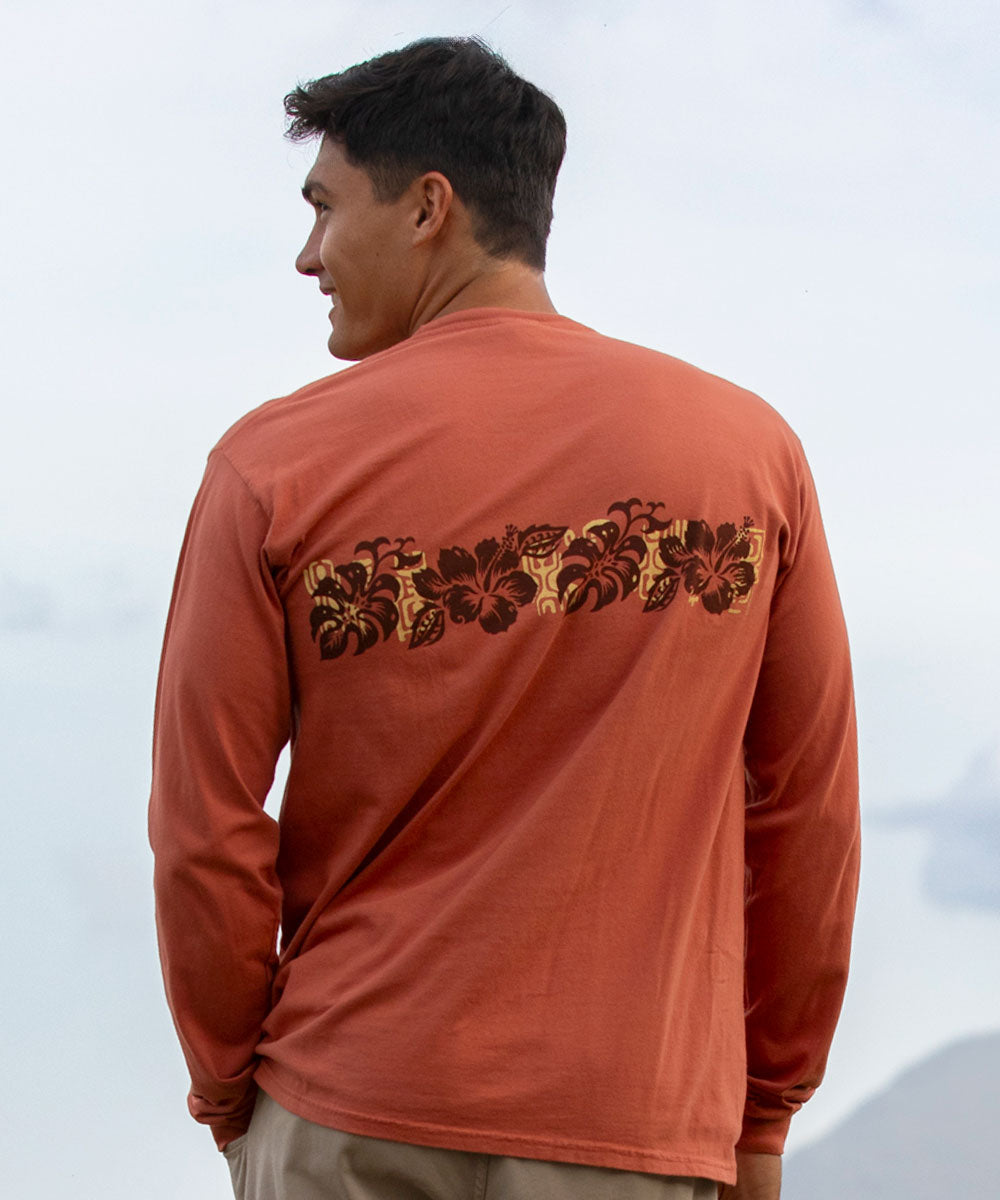 Man wearing a rust-colored long-sleeve shirt with a floral band design on the back against a white background View 3