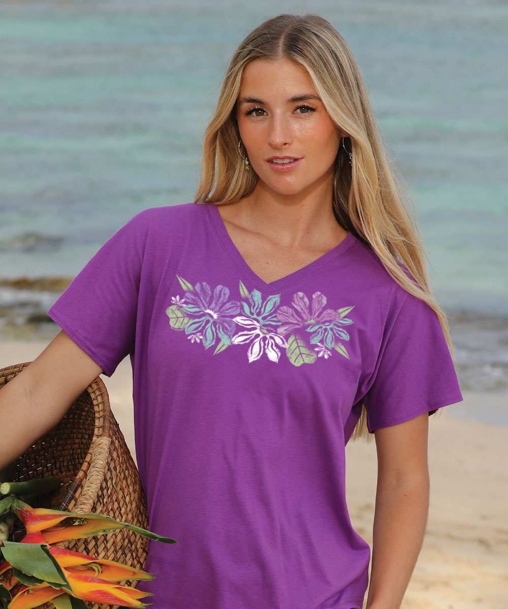 Woman wearing a purple t-shirt with floral design on a beach View 2