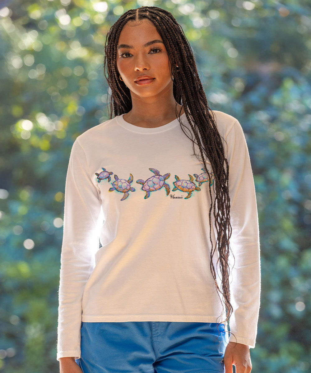 Woman wearing a white long-sleeve shirt with turtle design outdoors View 2