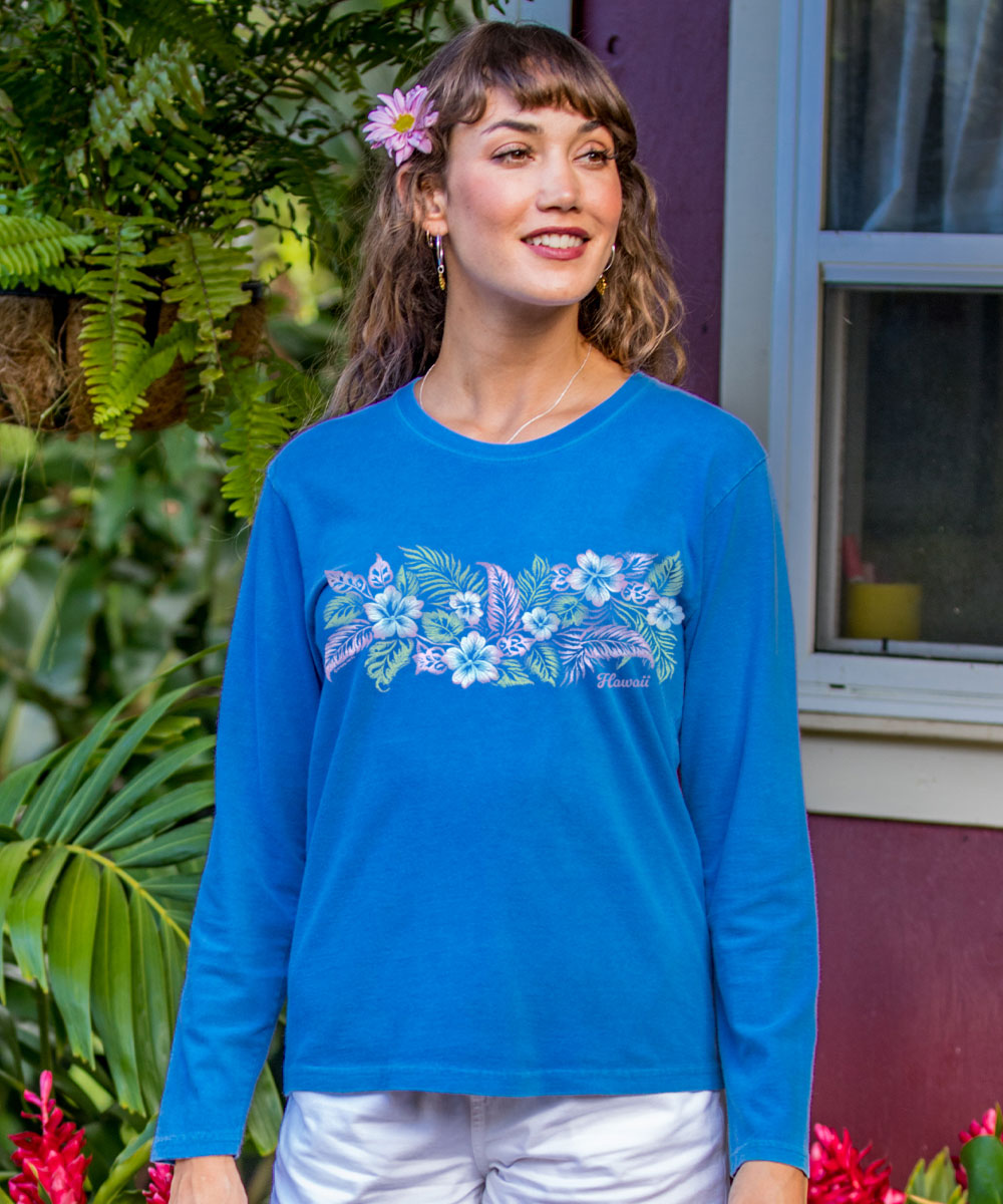 Woman wearing a blue long-sleeve shirt with floral design outdoors View 2