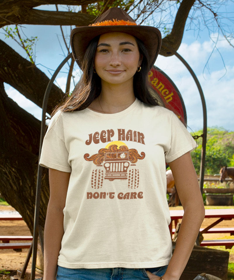 Person wearing a t-shirt with 'Jeep Hair Don't Care' design in a ranch setting View 2