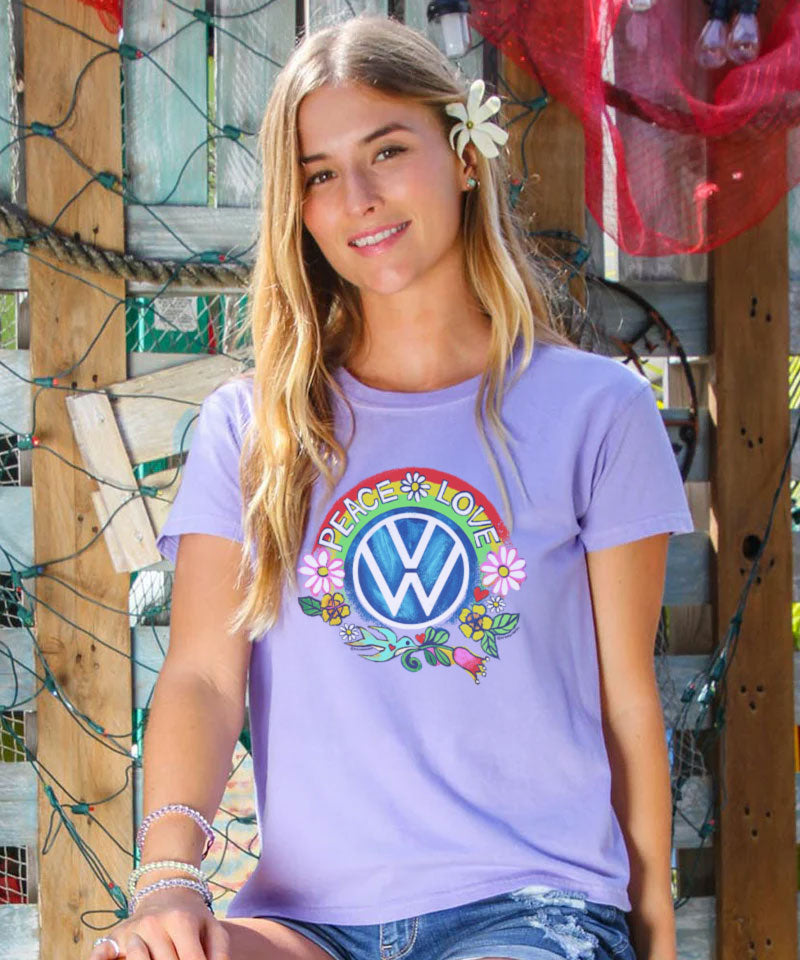 Woman wearing a purple t-shirt with a colorful Volkswagen logo and text. View 2