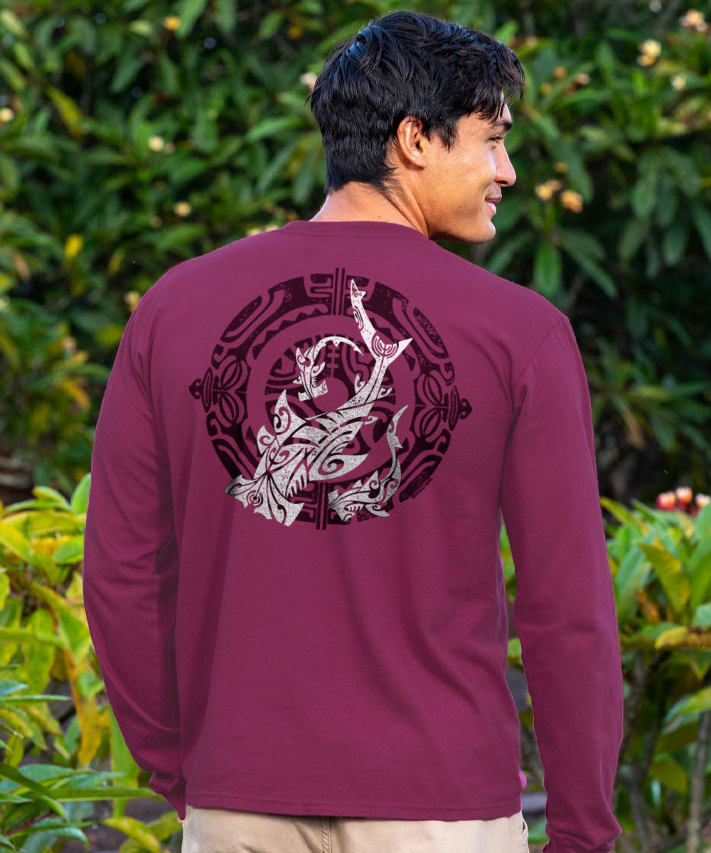 Man wearing a maroon long-sleeve shirt with a shark graphic design on the back, standing outdoors. View 2