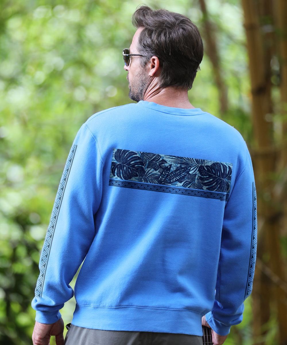Man wearing a blue sweatshirt with leaf pattern outdoors View 3
