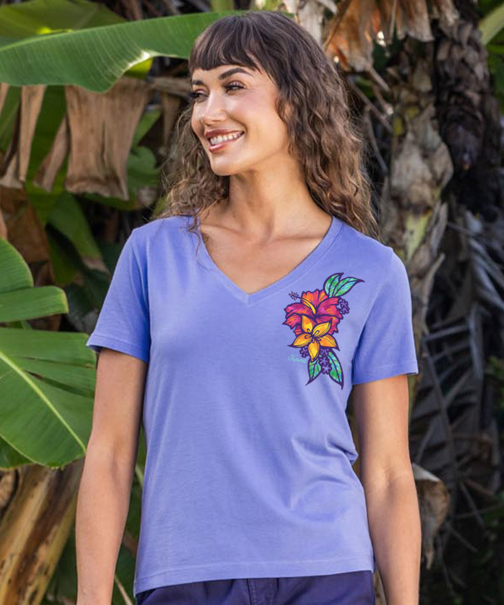 Woman wearing a purple t-shirt with a colorful floral design outdoors. View 2