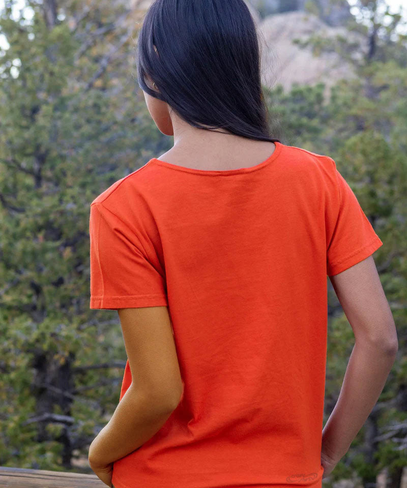 Person wearing an orange t-shirt with a forest background View 3