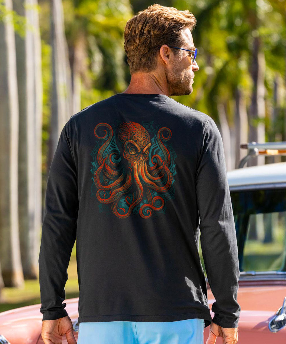 Man wearing a black long-sleeve shirt with a colorful octopus design outdoors. View 2